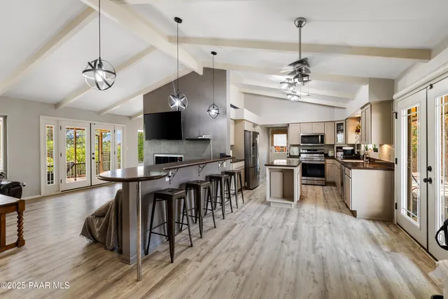 a view of a kitchen with sink microwave and stove