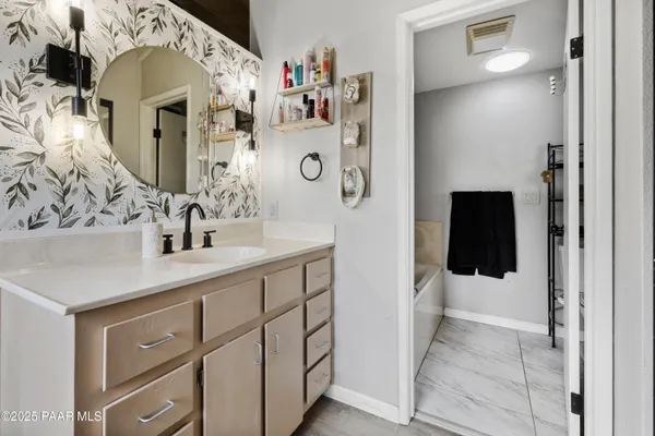a bathroom with a sink and mirror