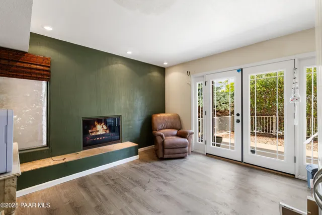a living room with furniture and a floor to ceiling window