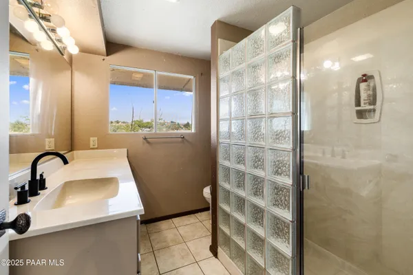 a bathroom with a sink a toilet and mirror