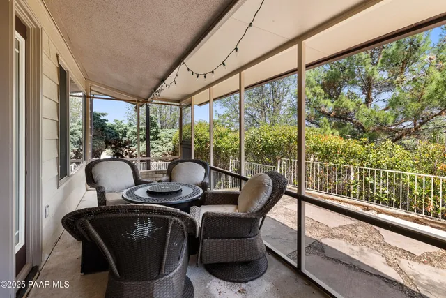 a living room with furniture and floor to ceiling windows