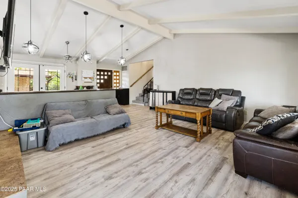 a living room with furniture and wooden floor