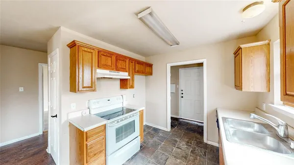 a spacious bathroom with a granite countertop sink and a mirror