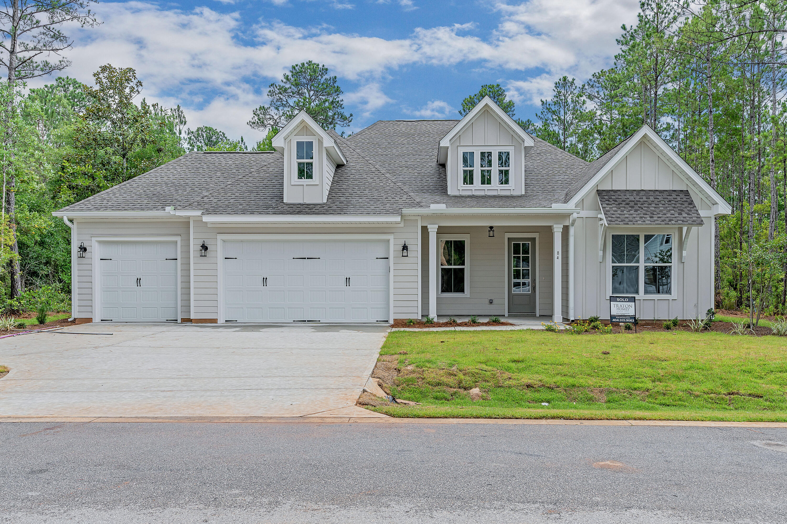 a front view of a house with a yard garage and outdoor seating