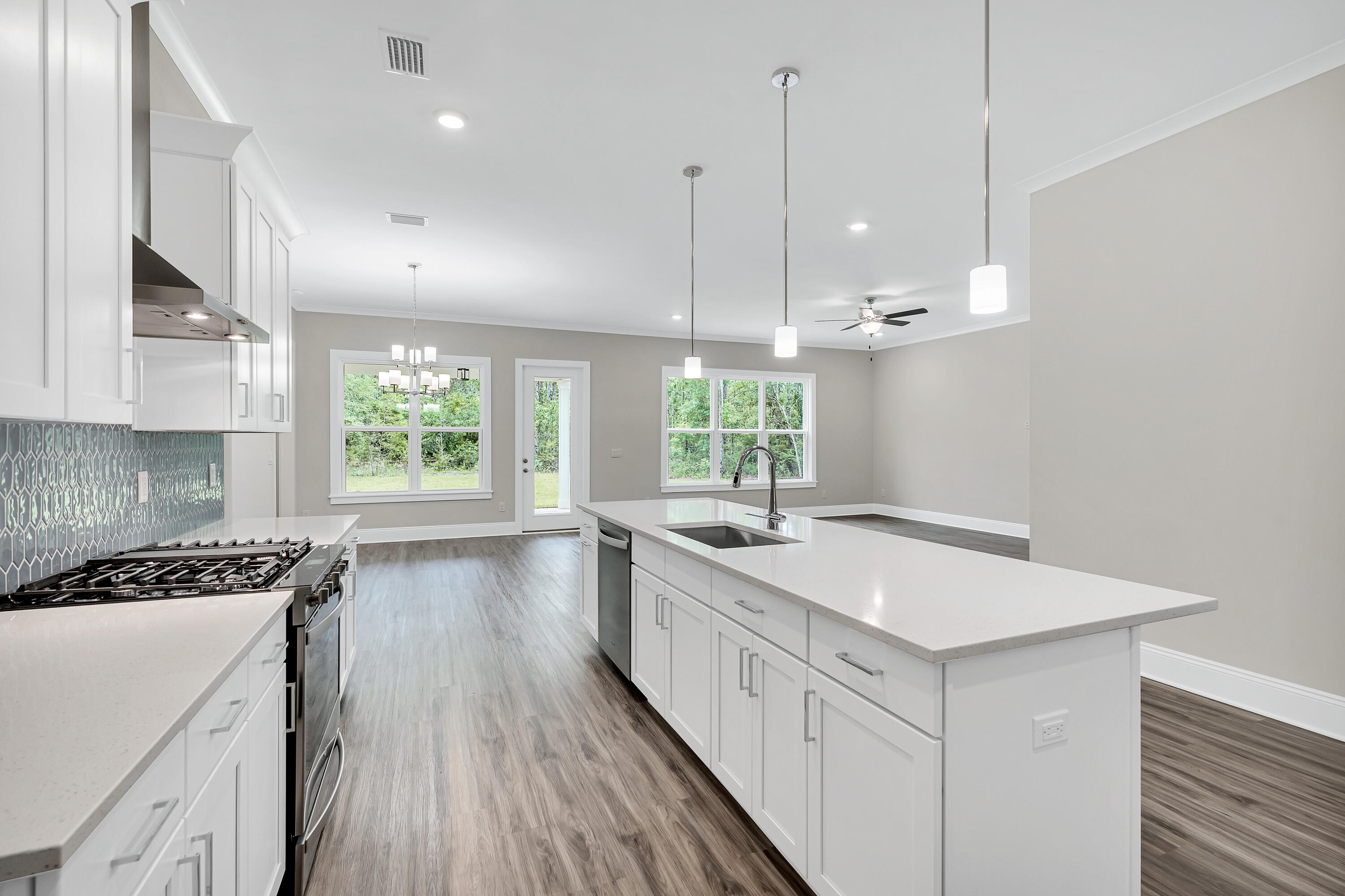 0 South J Hunter's Way, Unit LOT 18 Freeport, FL 32439 - Photo 10 of 36 a kitchen with a sink stove and wooden floor