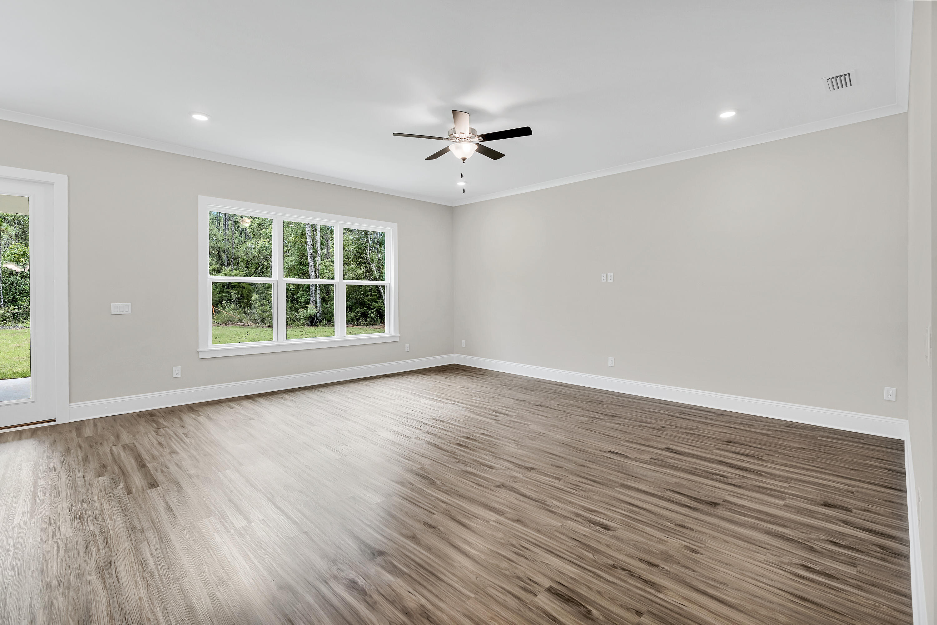 0 South J Hunter's Way, Unit LOT 18 Freeport, FL 32439 - Photo 12 of 36 an empty room with wooden floor and windows