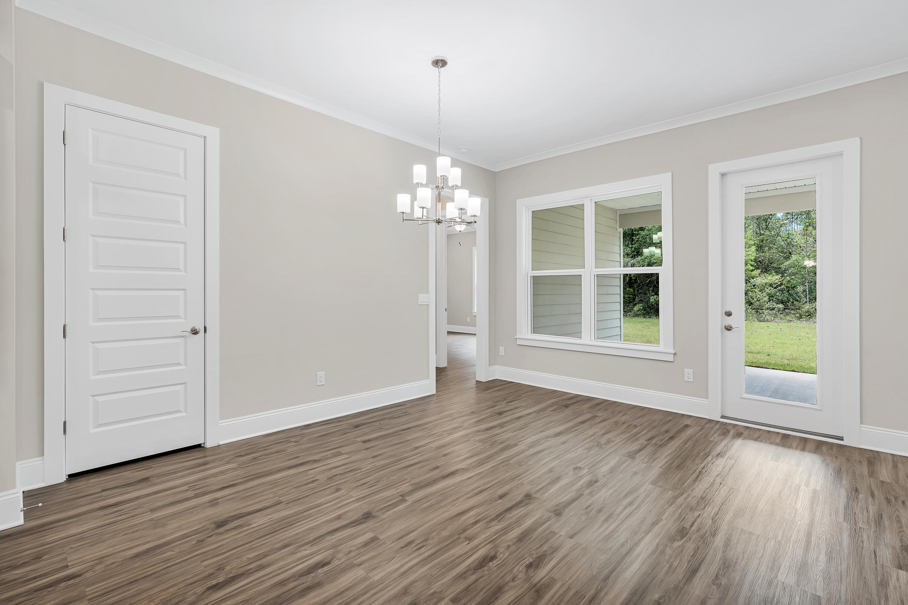 0 South J Hunter's Way, Unit LOT 18 Freeport, FL 32439 - Photo 17 of 36 an empty room with wooden floor cabinet and windows
