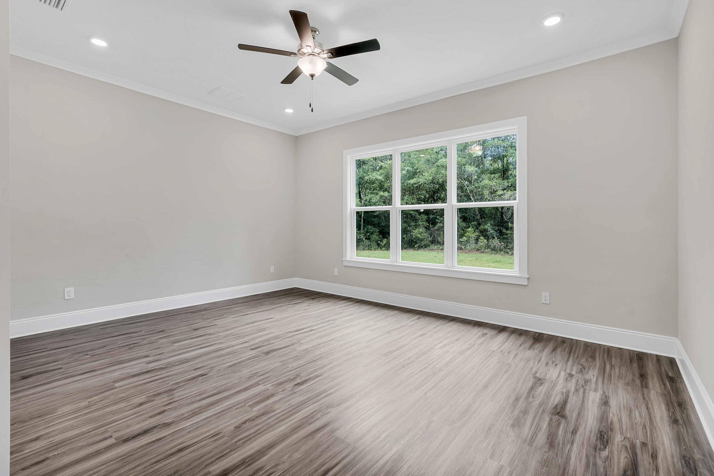 0 South J Hunter's Way, Unit LOT 18 Freeport, FL 32439 - Photo 18 of 36 an empty room with wooden floor and windows