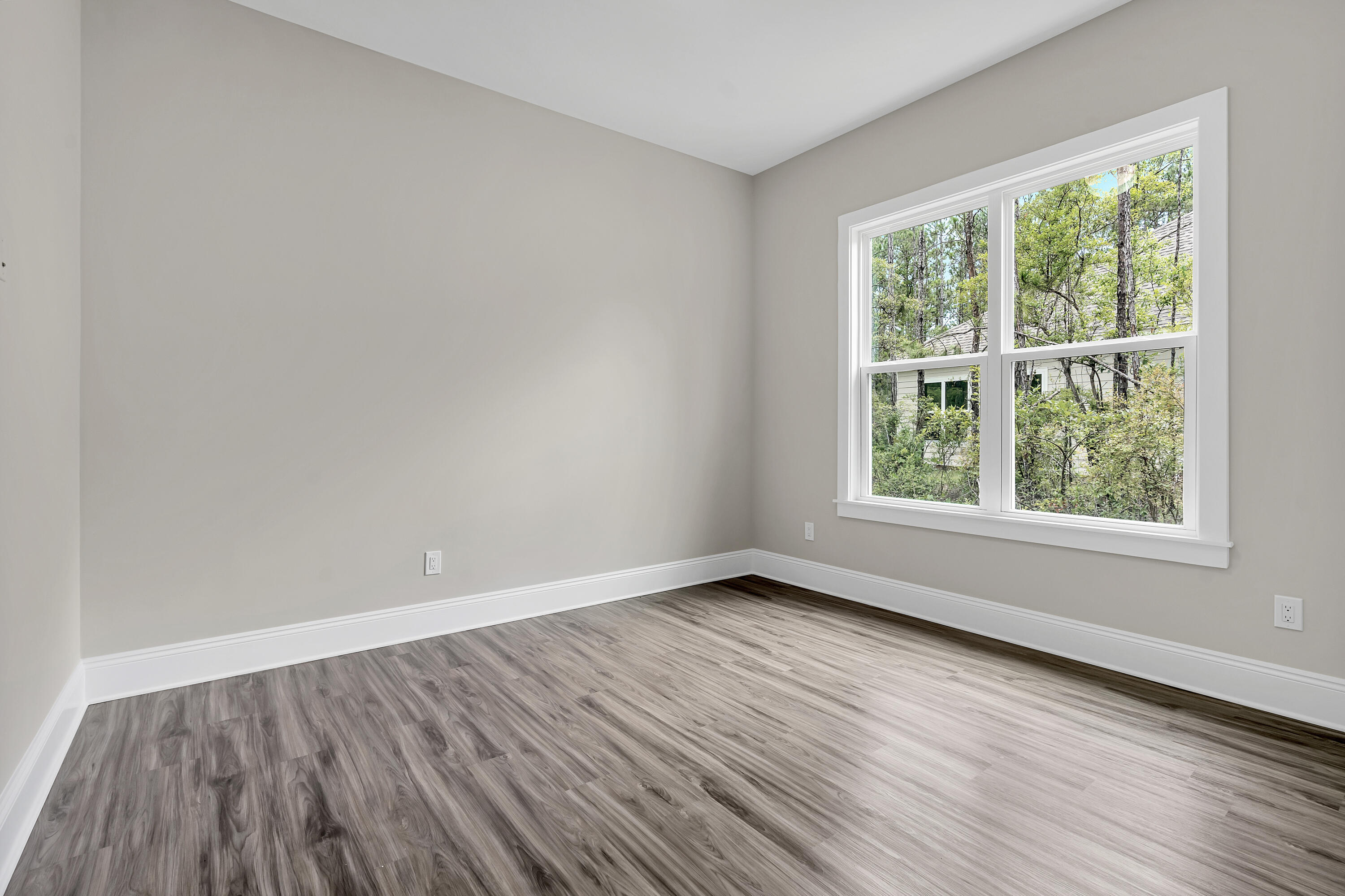 0 South J Hunter's Way, Unit LOT 18 Freeport, FL 32439 - Photo 24 of 36 an empty room with wooden floor and windows