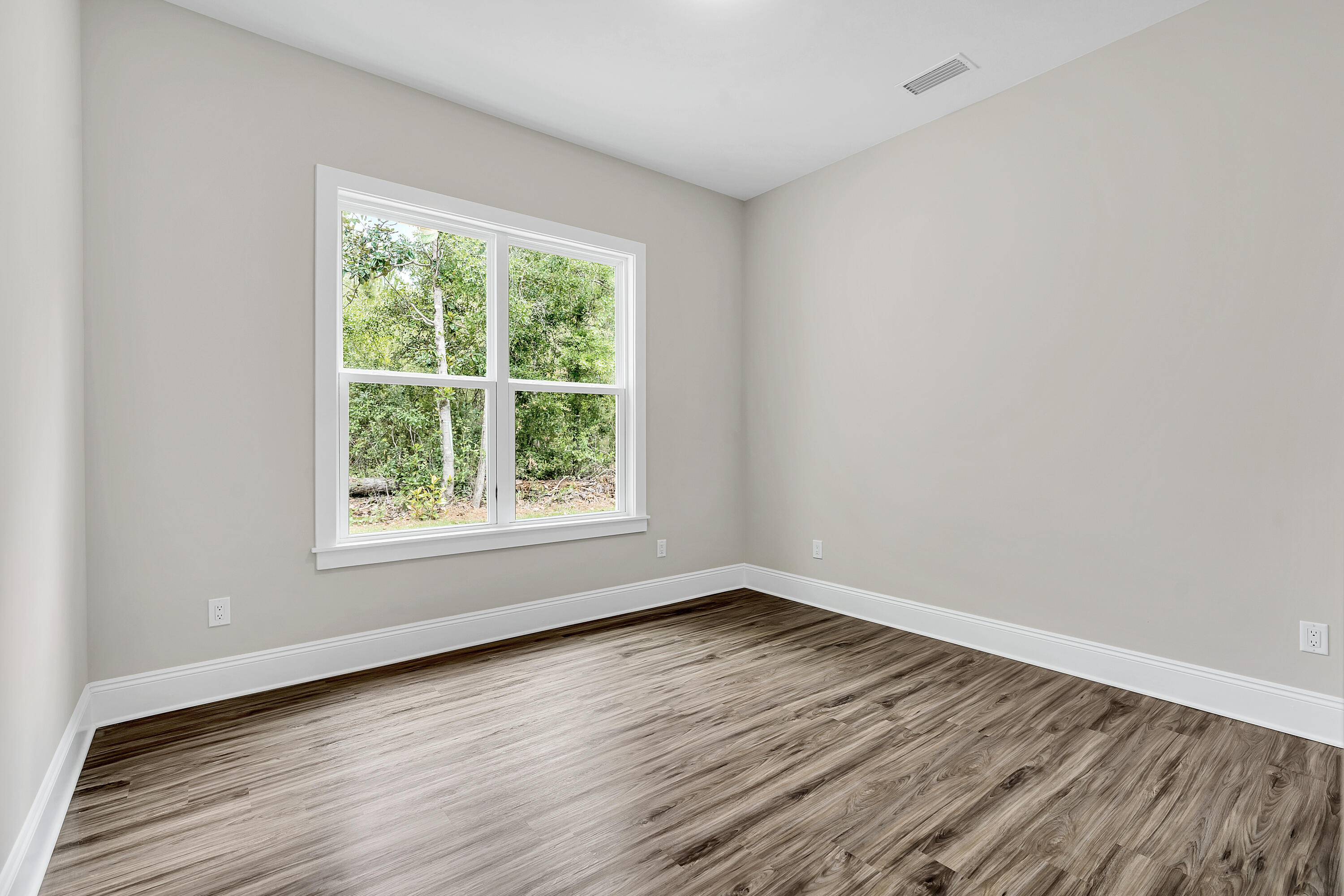 0 South J Hunter's Way, Unit LOT 18 Freeport, FL 32439 - Photo 27 of 36 a view of an empty room with wooden floor and a window
