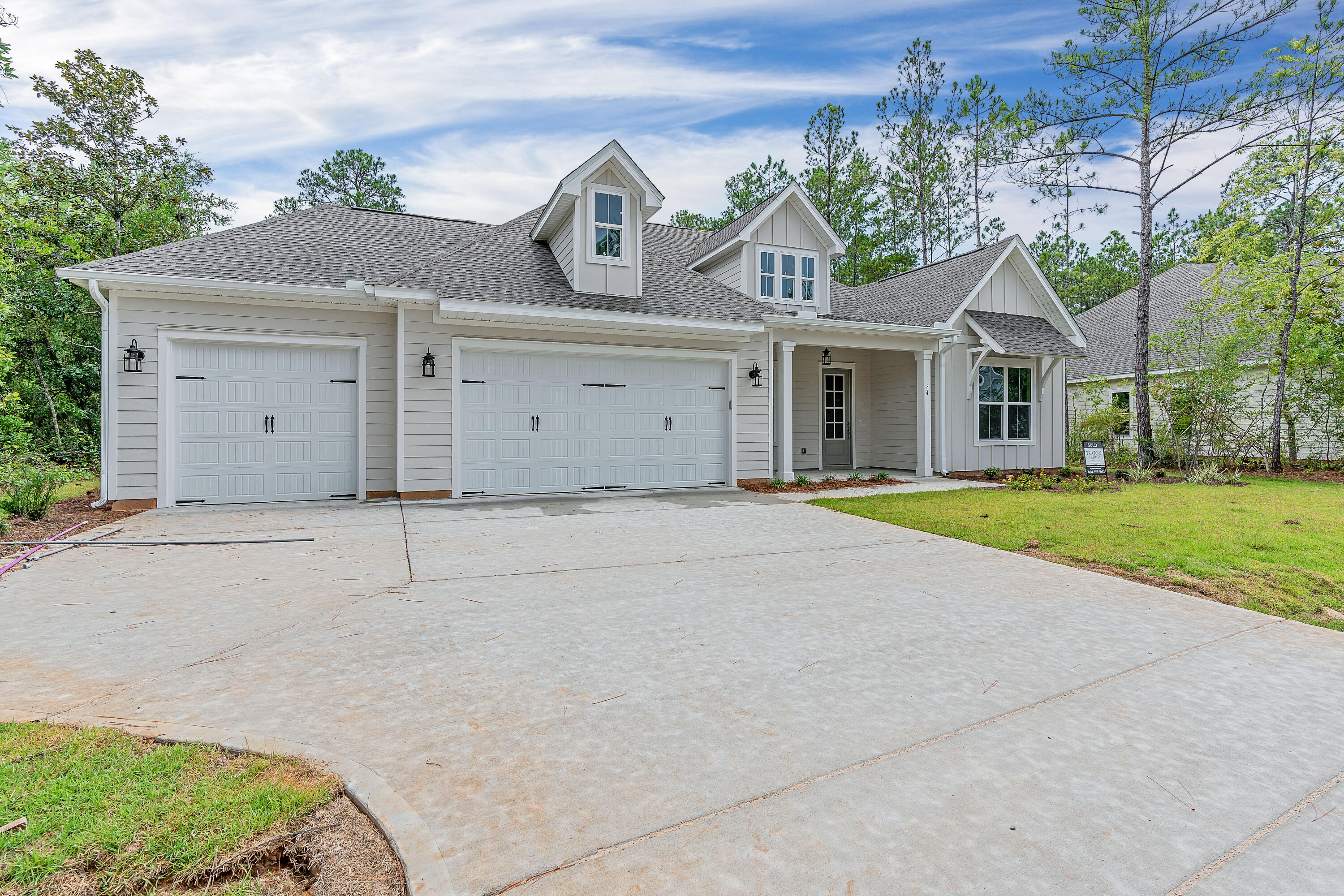 0 South J Hunter's Way, Unit LOT 18 Freeport, FL 32439 - Photo 2 of 36 a front view of a house with a garden and trees