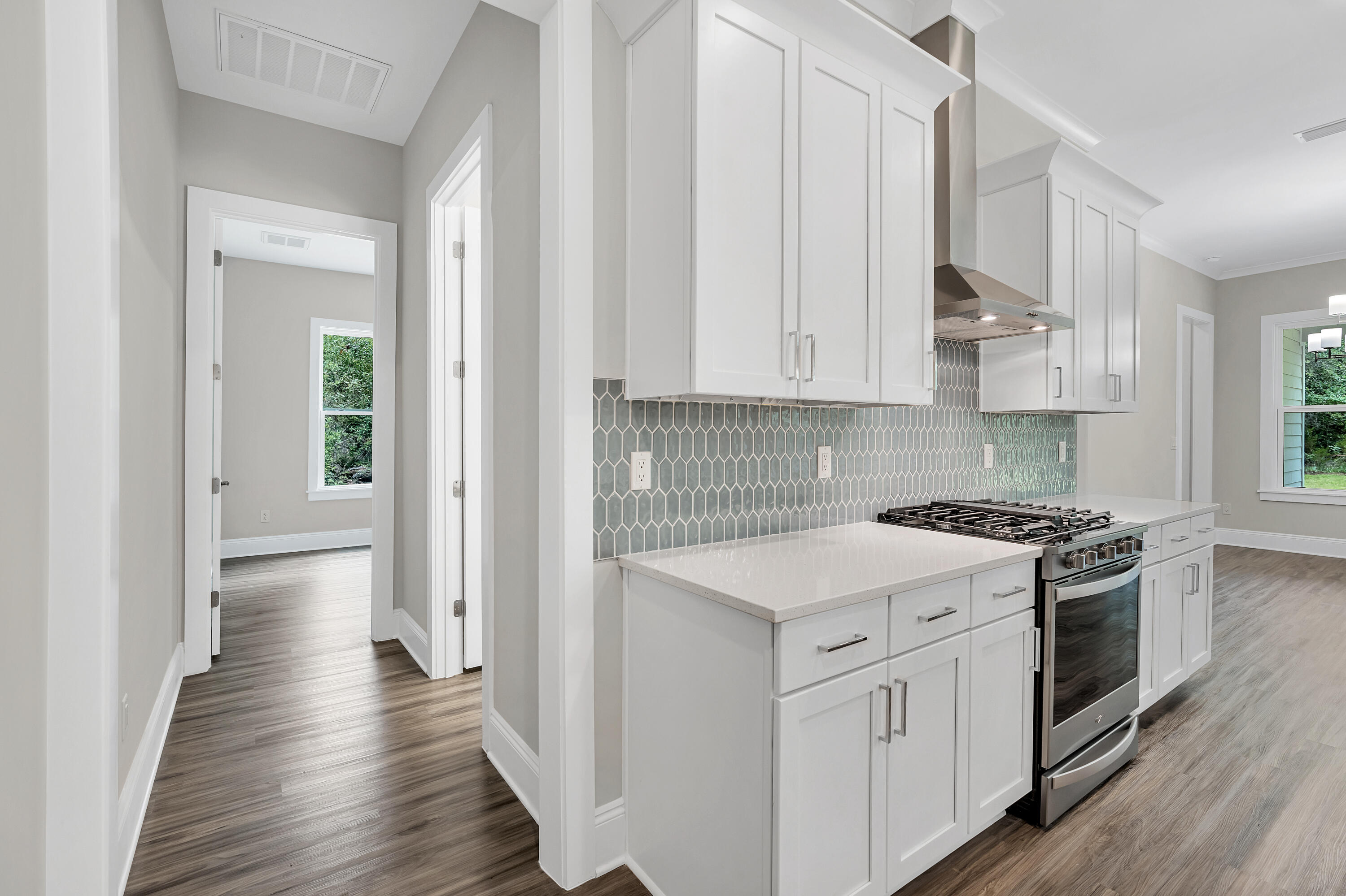 0 South J Hunter's Way, Unit LOT 18 Freeport, FL 32439 - Photo 6 of 36 a kitchen with a stove top oven sink and cabinets