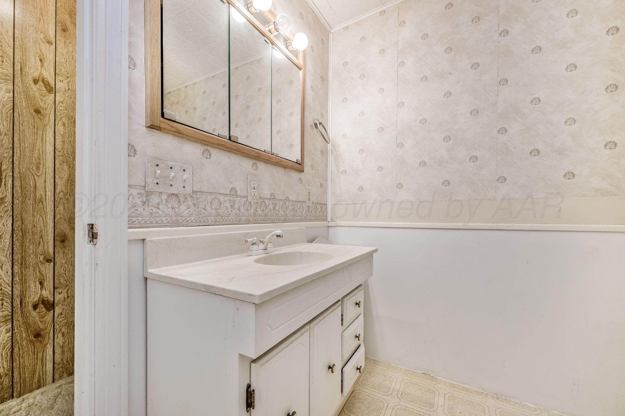 2133 Hamilton Street Pampa, TX 79065 - Photo 13 of 21 a bathroom with a sink and a mirror