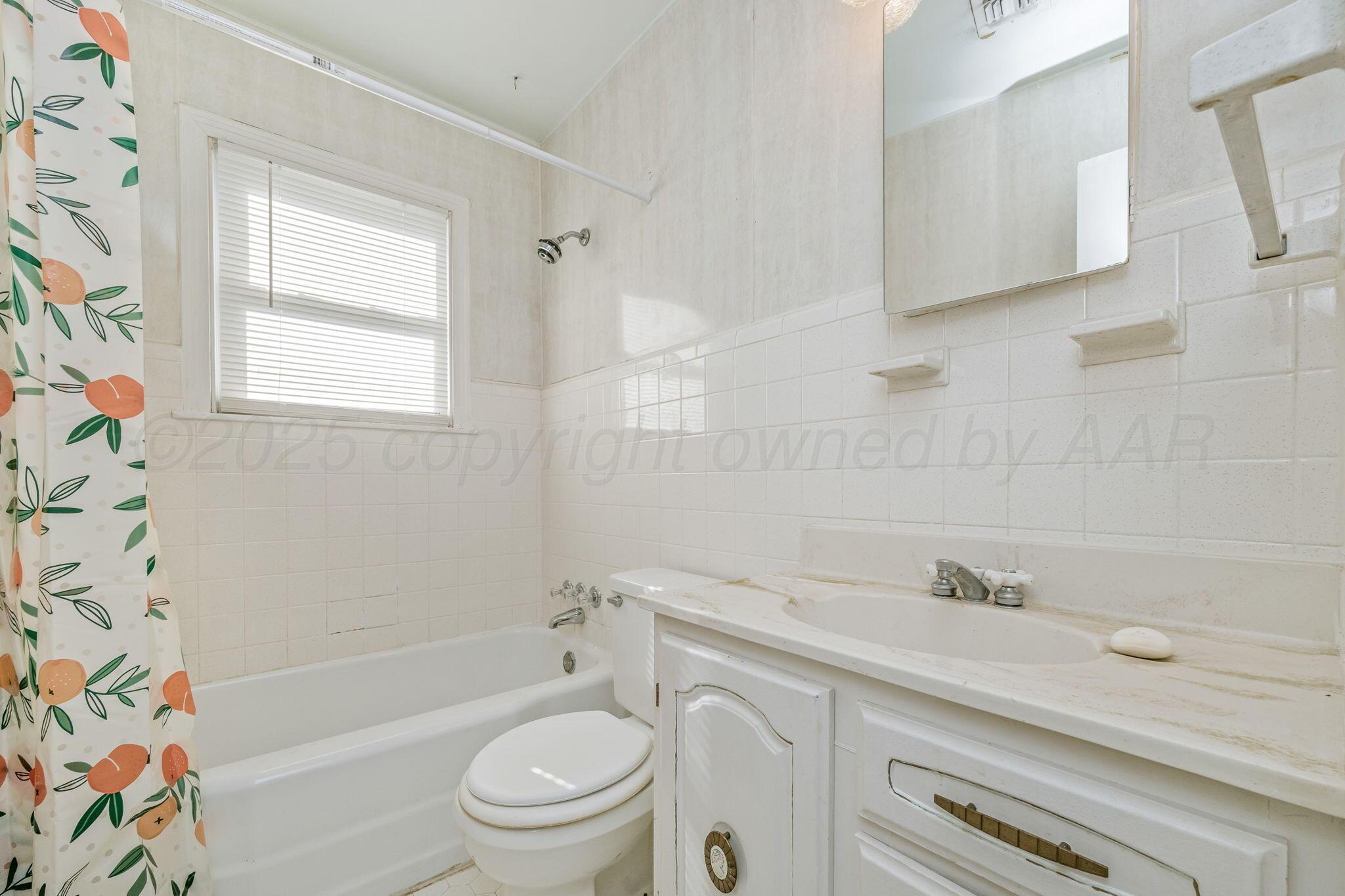 2133 Hamilton Street Pampa, TX 79065 - Photo 18 of 21 a bathroom with a sink a toilet and a bathtub