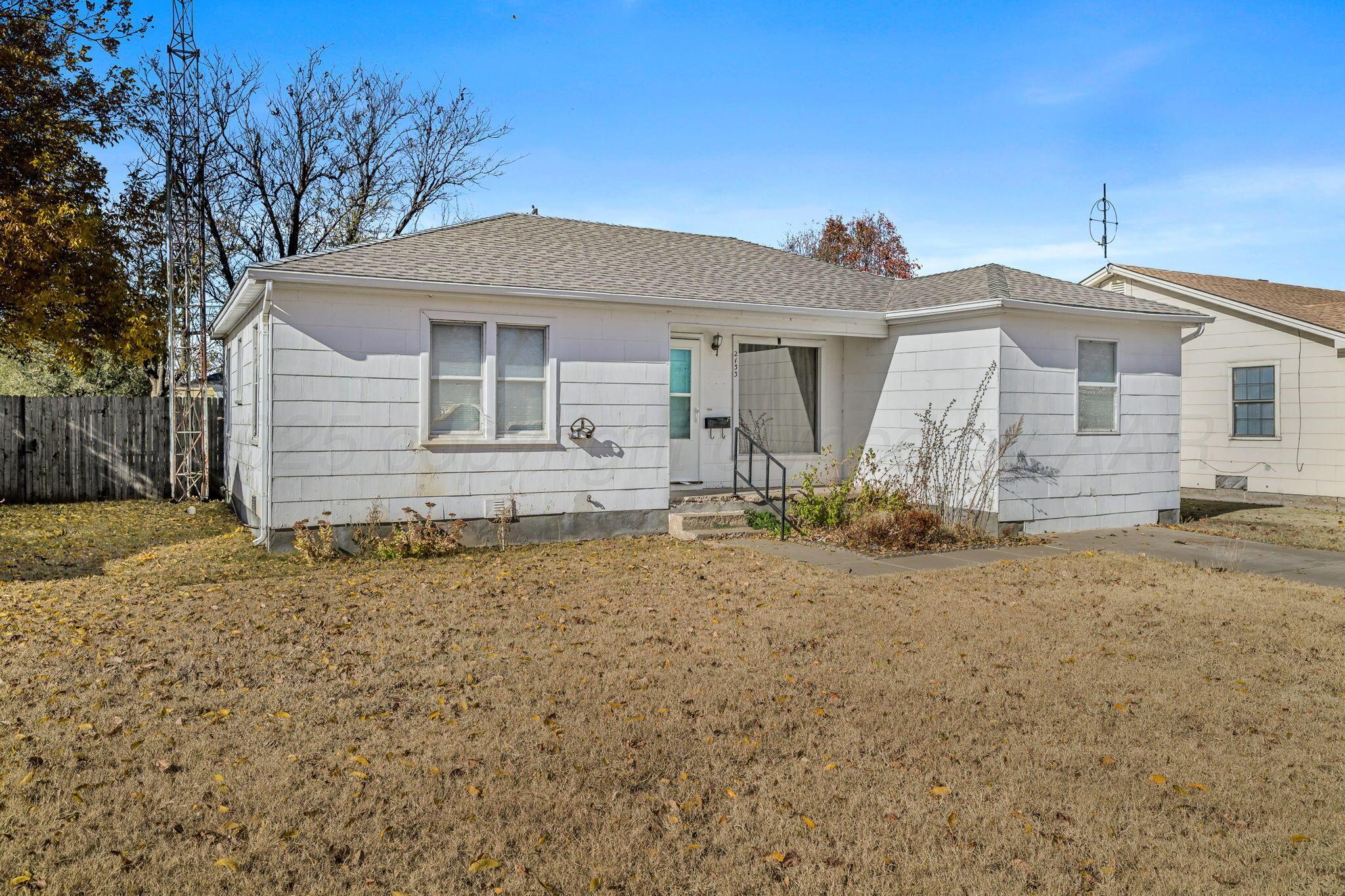 2133 Hamilton Street Pampa, TX 79065 - Photo 2 of 21 a front view of a house with garden