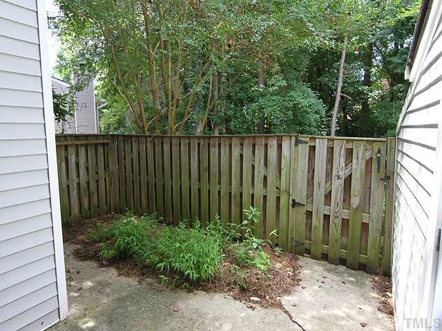 153 Newton Road Raleigh, NC 27615 - Photo 12 of 13 a view of a pathway in a backyard with potted plants