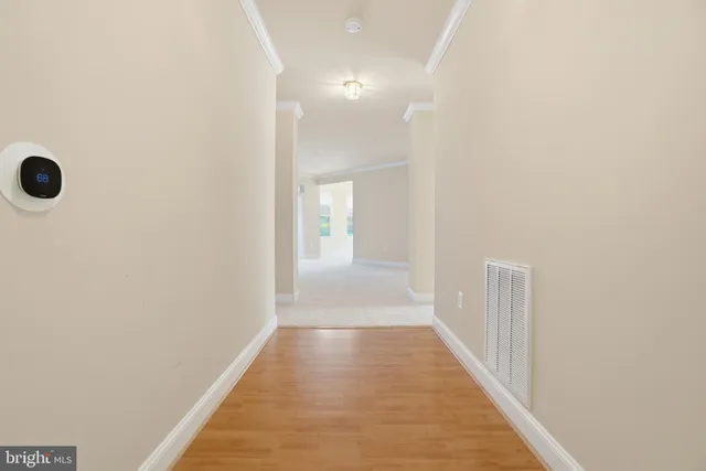 a kitchen with stainless steel appliances granite countertop a stove top oven a refrigerator a sink and dishwasher with white cabinets