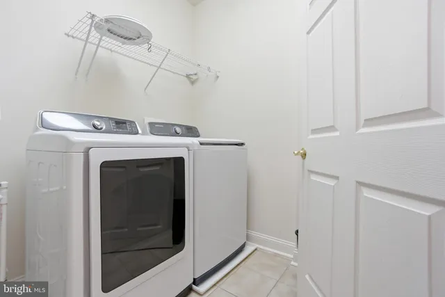 a front view of a house with a yard and potted plants