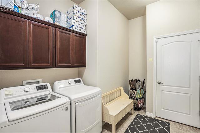 9709 Rockingham Drive Peyton, CO 80831 - Photo 17 of 50 Laundry room featuring separate washer and dryer and cabinet space