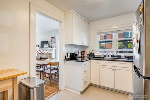a kitchen with stainless steel appliances granite countertop a sink and cabinets