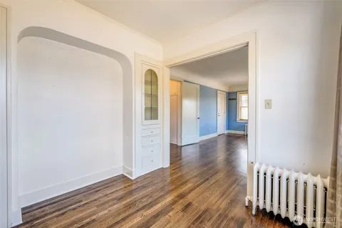 a view of a room with wooden floor