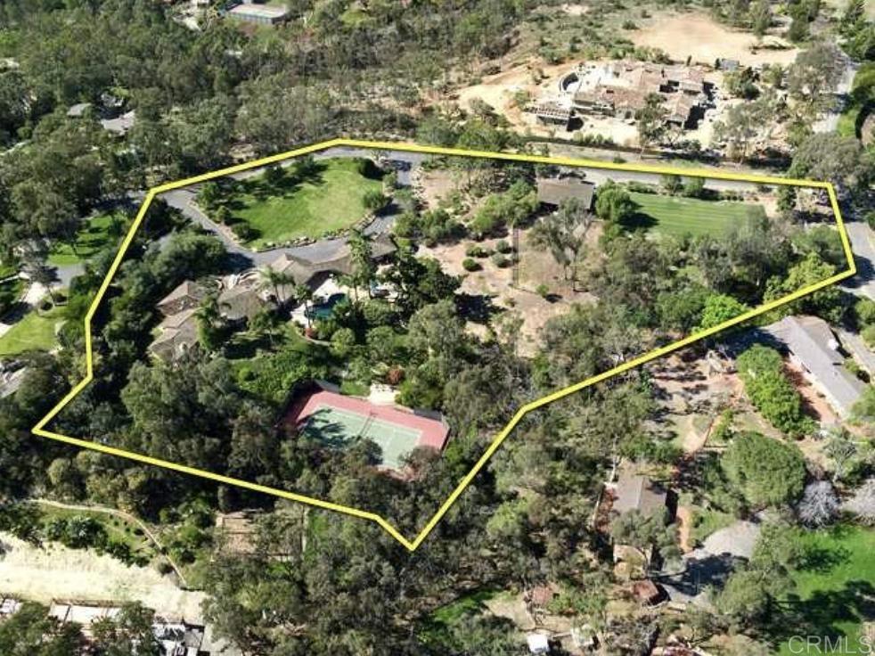 a backyard of a house with lots of green space and plants
