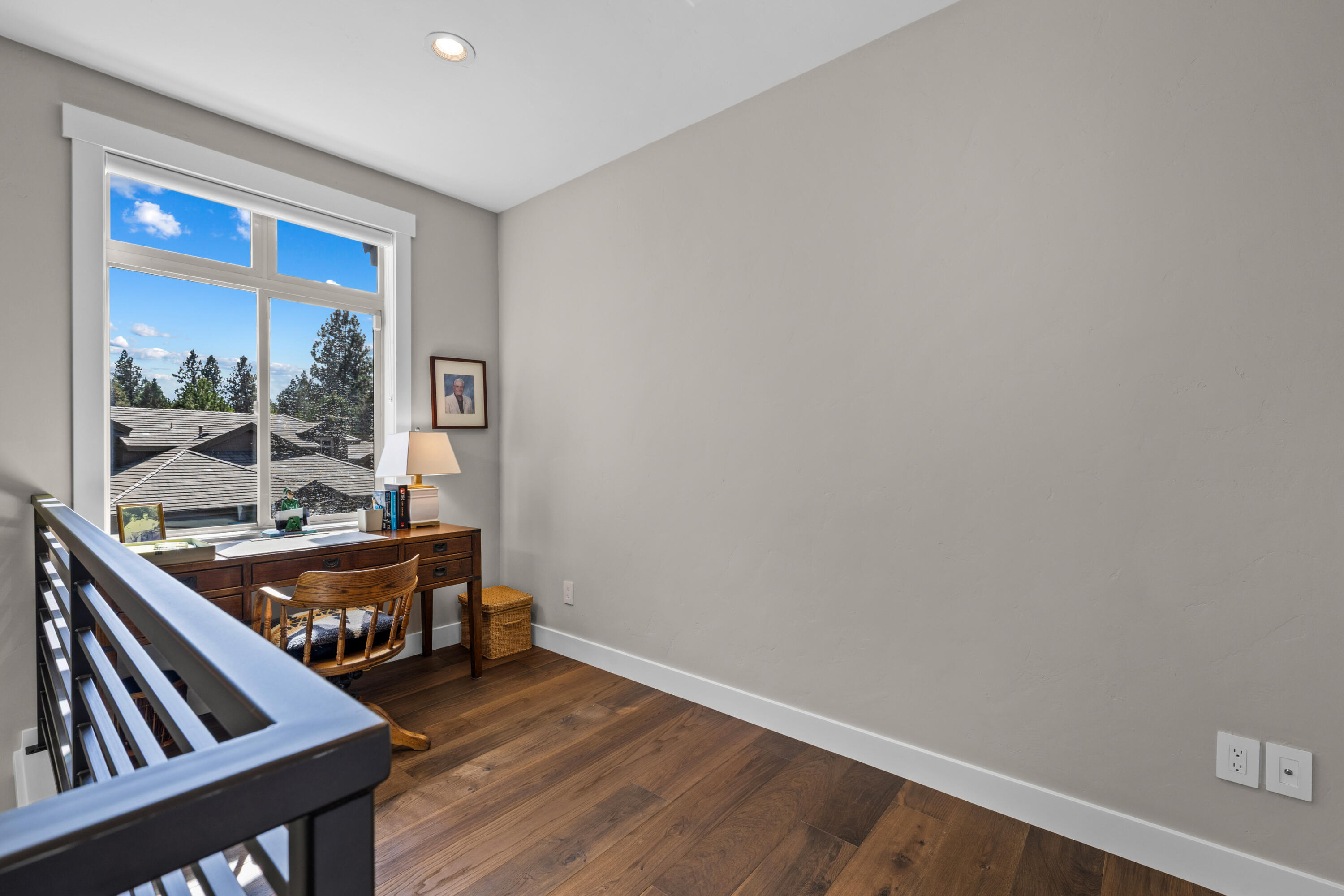 19460 Chip Shot Lane Bend, OR 97702 - Photo 45 of 56 a room with wooden floor and furniture