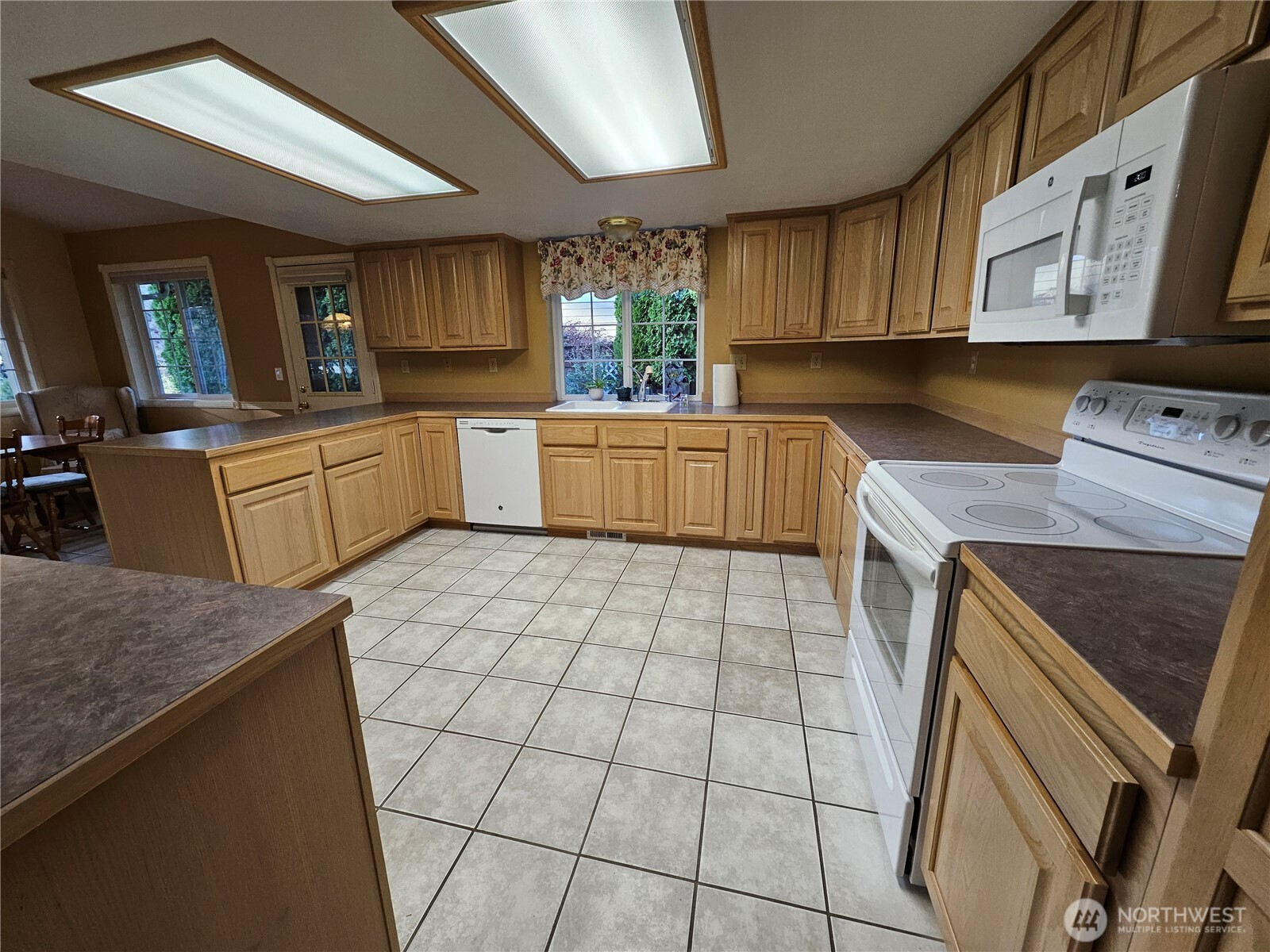 1121 East Old Ranch Road Allyn, WA 98524 - Photo 11 of 30 a kitchen with a sink a stove cabinets and counter space