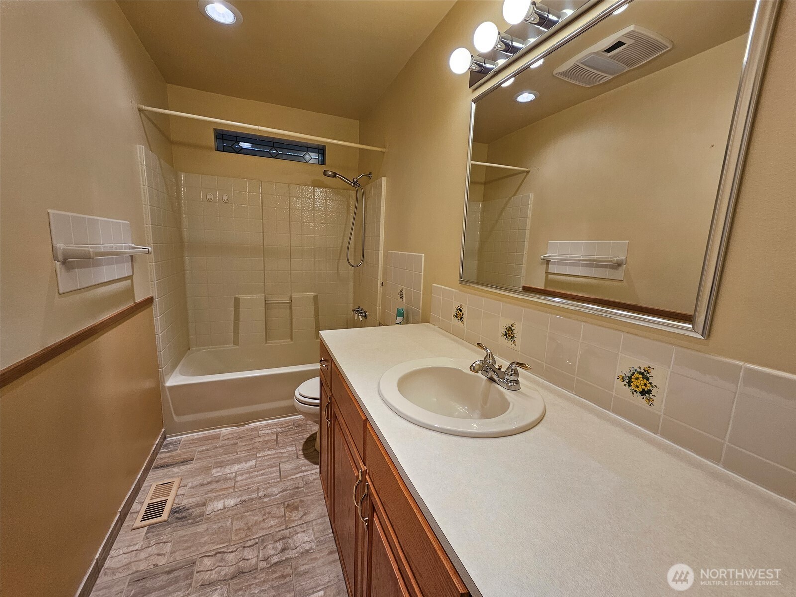 1121 East Old Ranch Road Allyn, WA 98524 - Photo 17 of 30 a bathroom with a sink a mirror and a shower