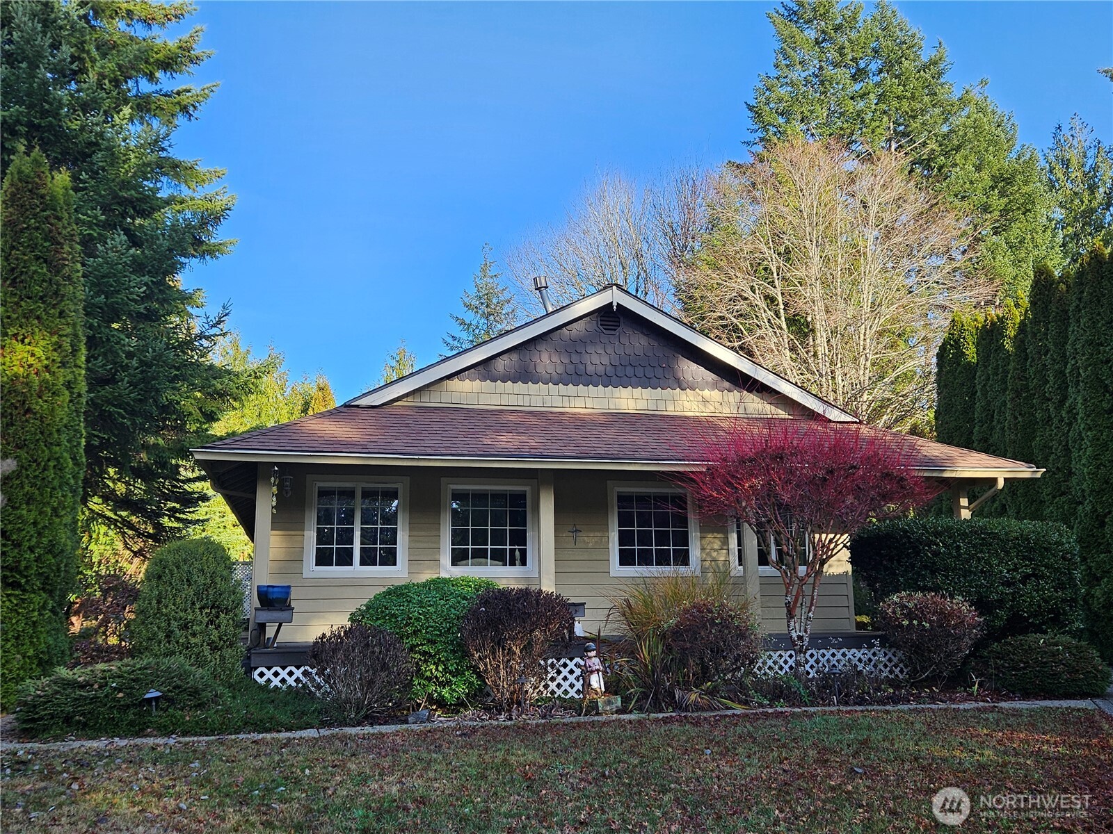 1121 East Old Ranch Road Allyn, WA 98524 - Photo 23 of 30 a front view of a house with garden
