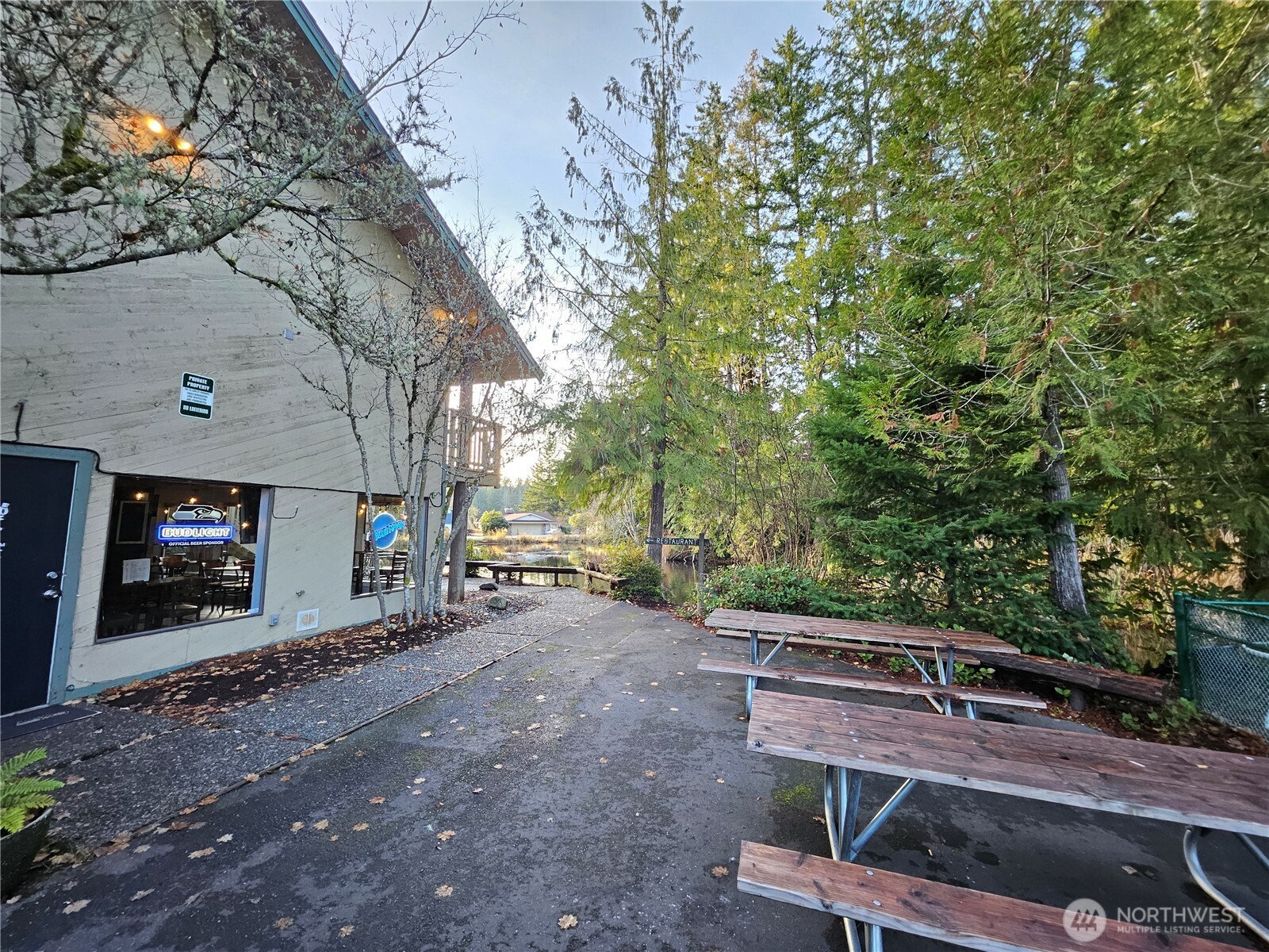 1121 East Old Ranch Road Allyn, WA 98524 - Photo 27 of 30 a view of a backyard with chairs and a fire pit