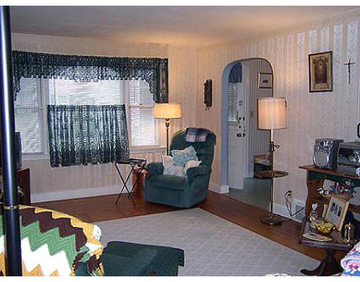 154 Fiberloid Street Springfield, MA 01151 - Photo 5 of 8 a living room with furniture and a lamp