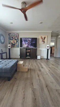 a living room with furniture and paintings on the wall