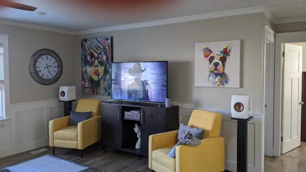 a living room with furniture and wooden floor