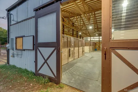 a kitchen with a stove a sink a dining table and chairs