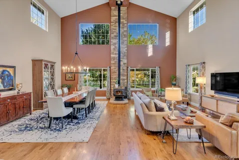 a living room with furniture a dining table and a potted plant