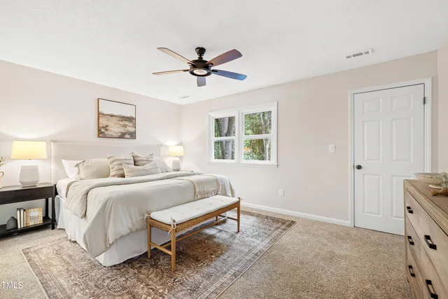 a spacious bedroom with a bed and a window