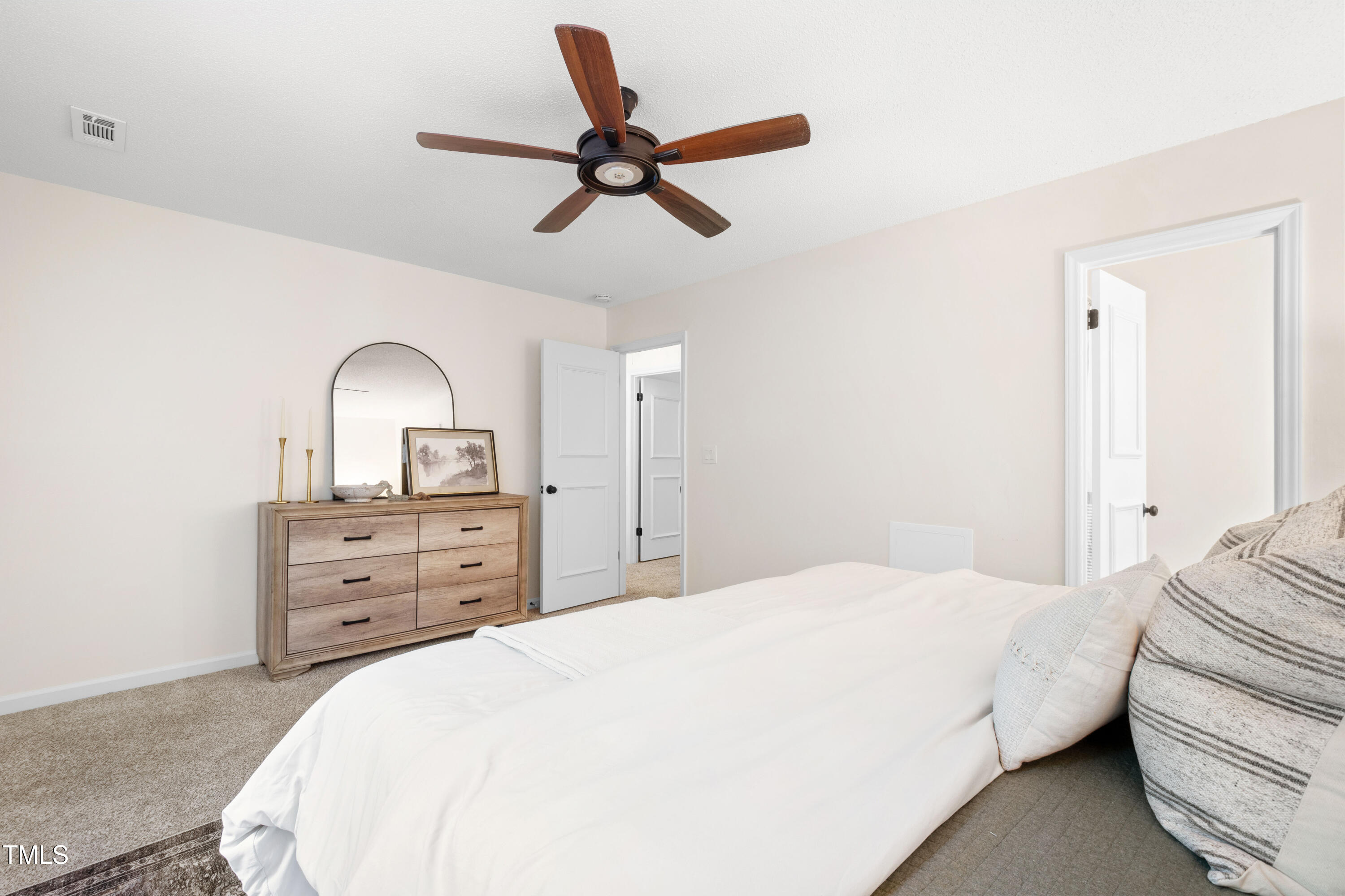 115 Inverness Court Cary, NC 27511 - Photo 14 of 40 a bedroom with a large bed and ceiling fan