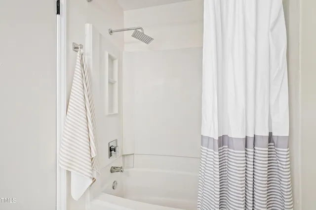 a bathroom with a bathtub and shower