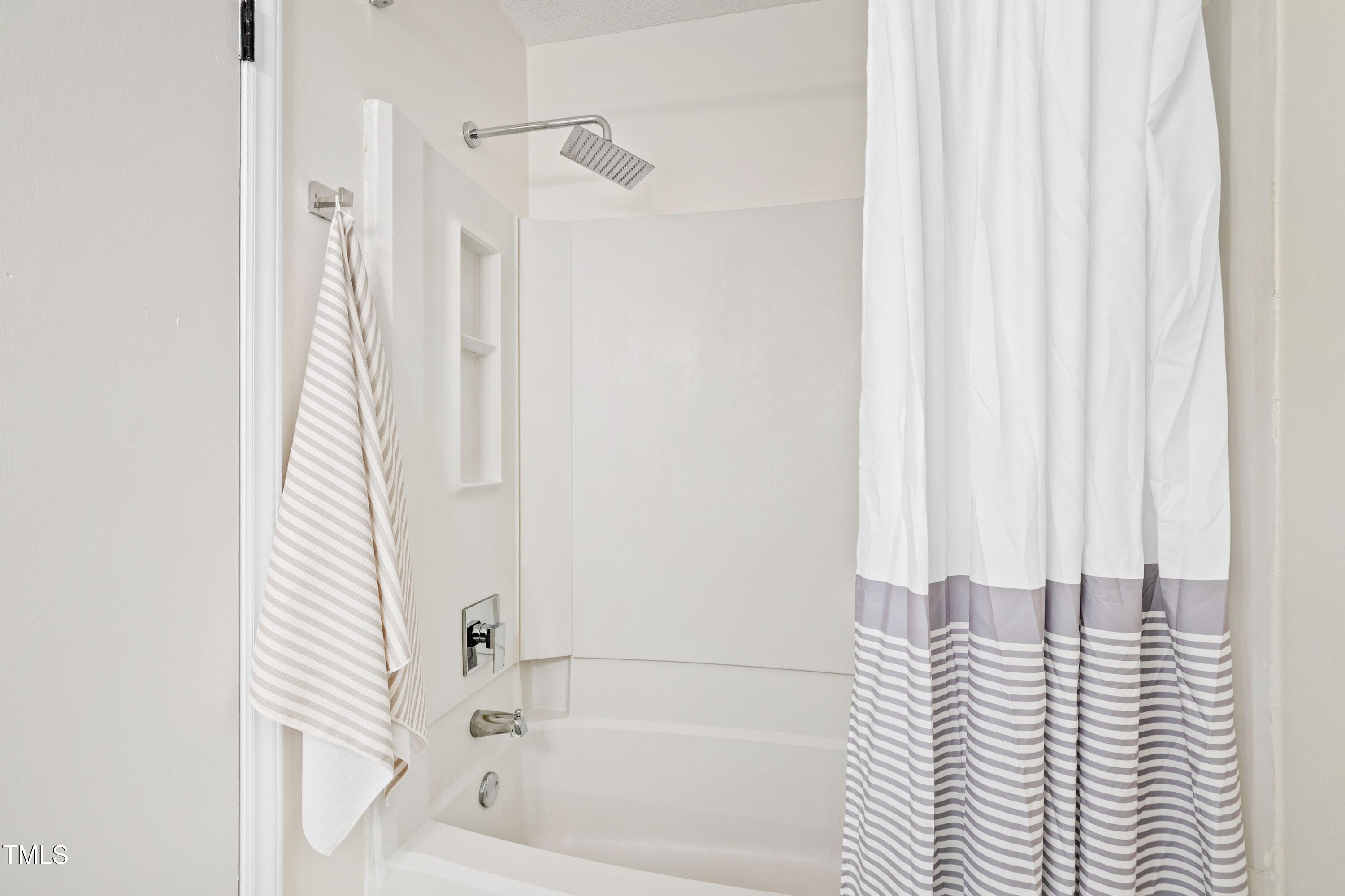 115 Inverness Court Cary, NC 27511 - Photo 17 of 40 a bathroom with a bathtub and shower