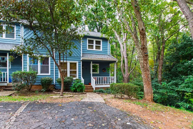 a front view of a house with garden and porch