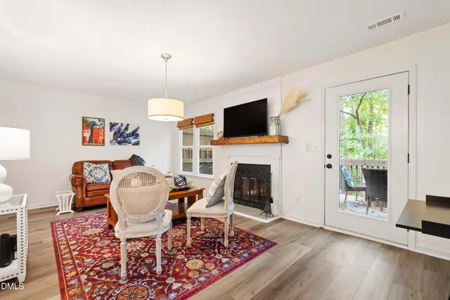 a living room with furniture a fireplace and a flat screen tv