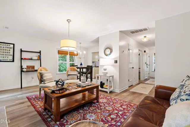 a living room with furniture and a chandelier