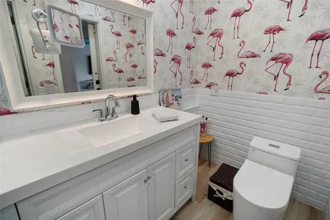 a bathroom with a sink toilet and a mirror