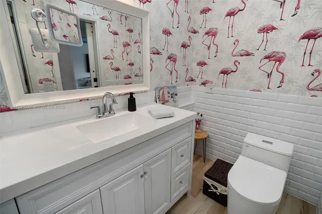 a bathroom with a sink toilet and a mirror