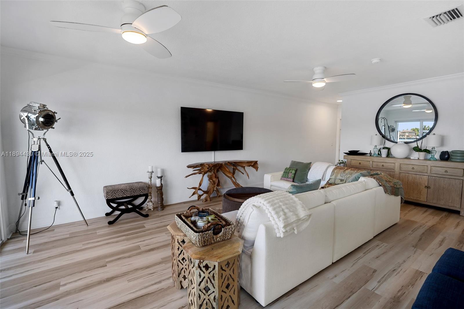 1201 South Riverside Drive, Unit 301 Pompano Beach, FL 33062 - Photo 4 of 24 a living room with furniture and a flat screen tv