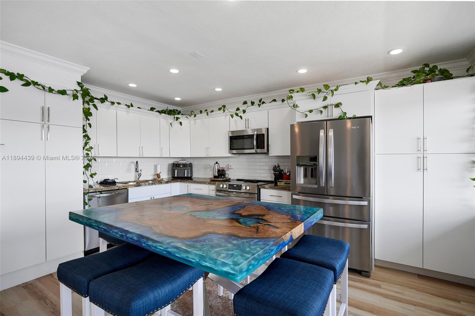 1201 South Riverside Drive, Unit 301 Pompano Beach, FL 33062 - Photo 5 of 24 a kitchen with stainless steel appliances granite countertop a stove refrigerator sink and cabinets