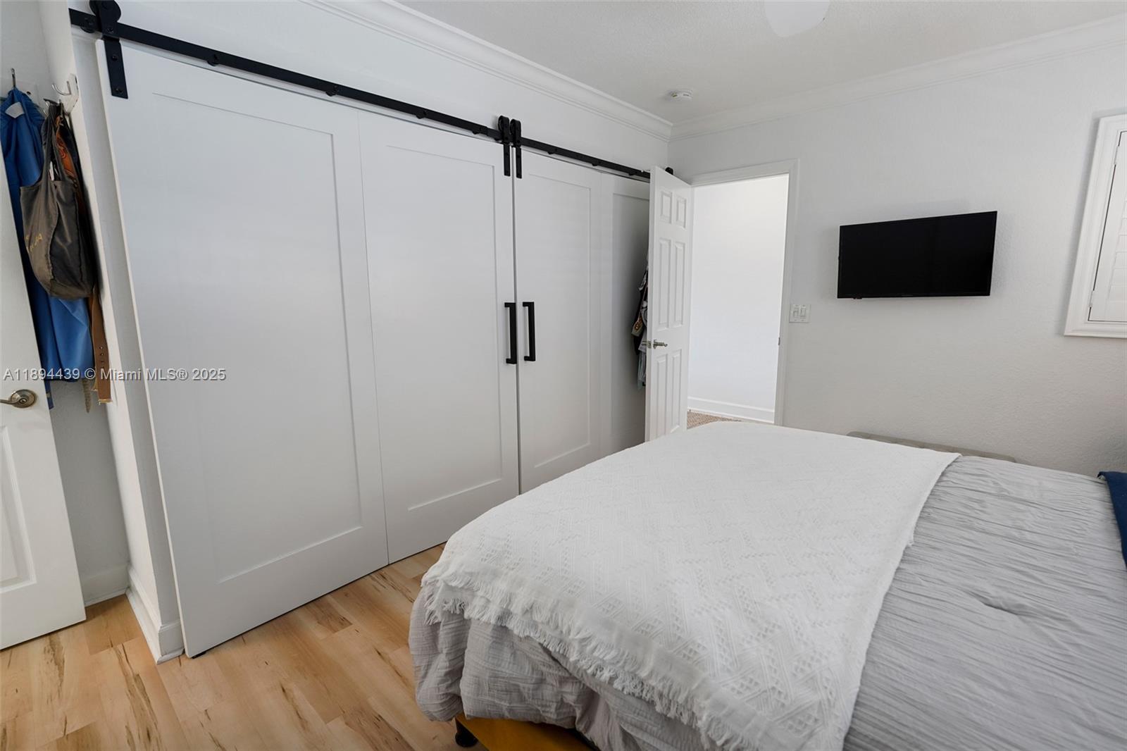 1201 South Riverside Drive, Unit 301 Pompano Beach, FL 33062 - Photo 10 of 24 a bedroom with a bed and a flat screen tv