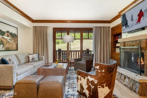 a living room with furniture and a floor to ceiling window