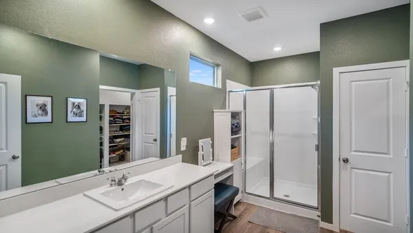 a bathroom with a double vanity sink mirror and shower